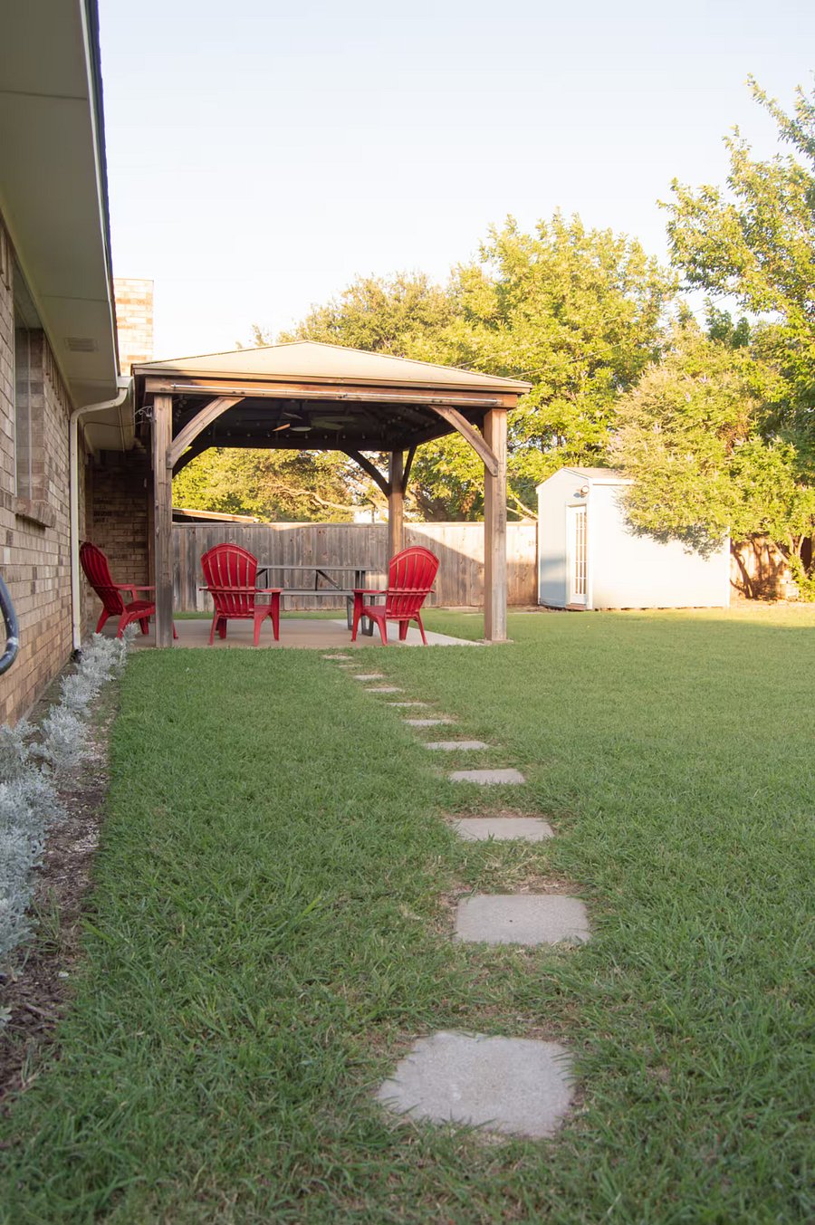 This covered patio includes seating, outdoor fan and patio lights.