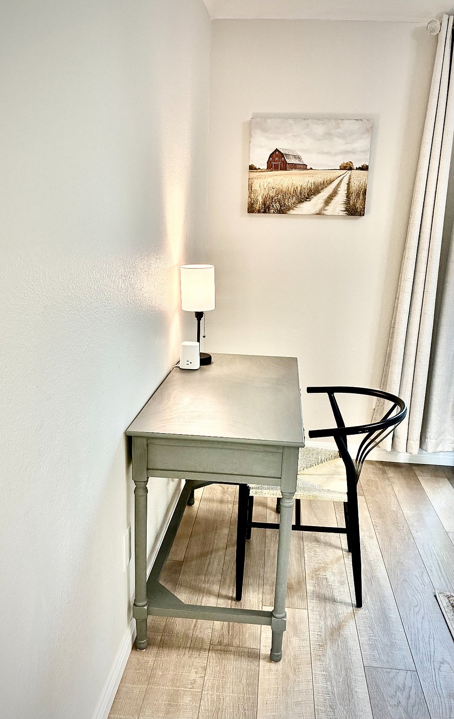 44-inch desk offers a convenient workspace. Perfect for setting up your laptop. A small lamp and charging tower are included for your convenience. This workspace is in the primary bedroom.