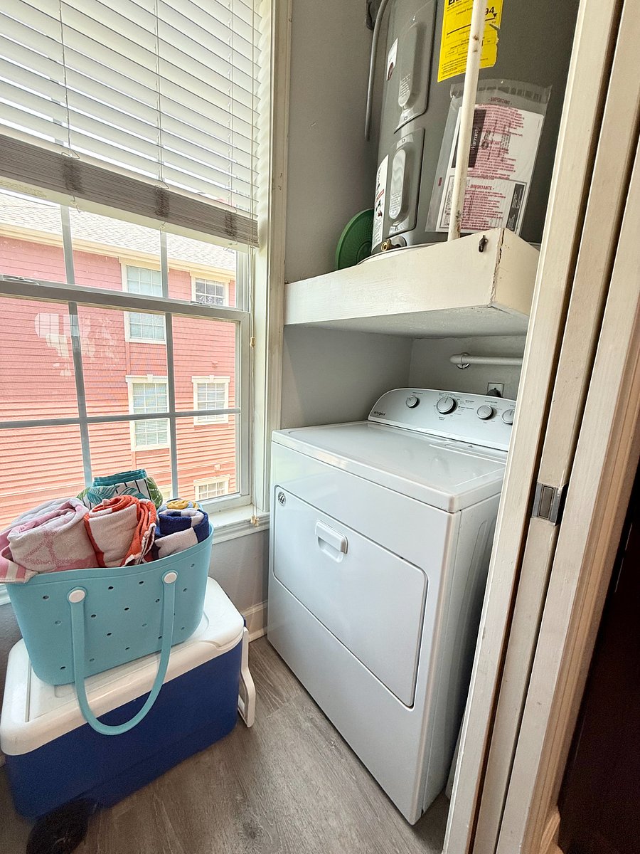utility room with full sized washer and dryer
