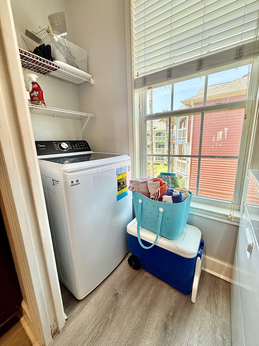 utility room with full size washer and dryer, beach bag & cooler