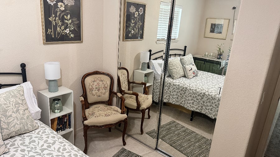Corner chair to sit to watch tv or read, full mirrored closet.