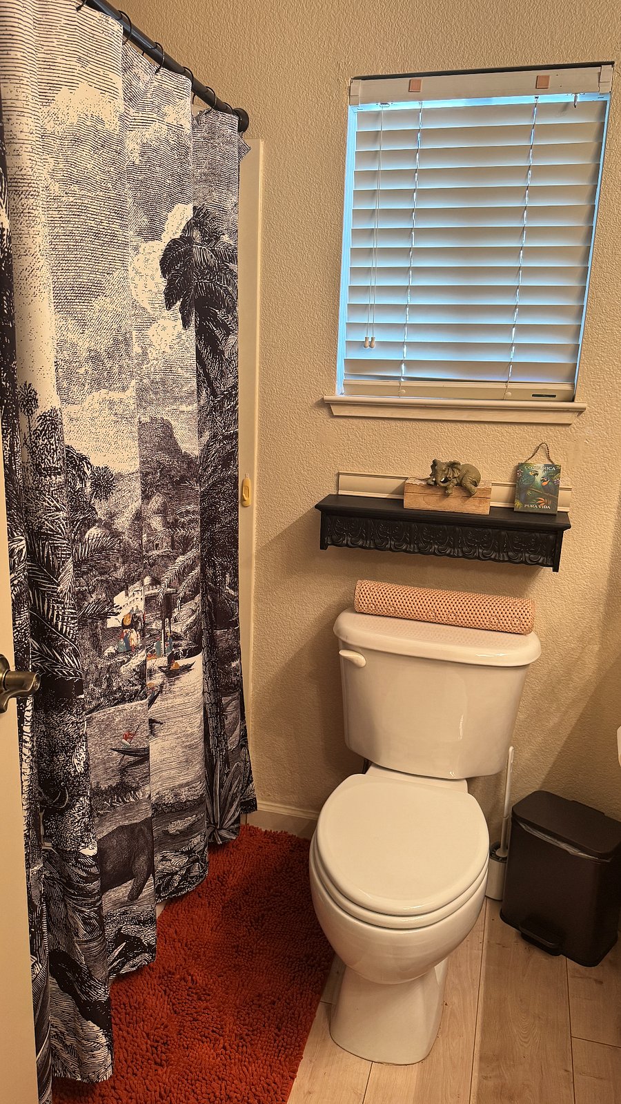 Bathroom bath/shower combo and toilet.