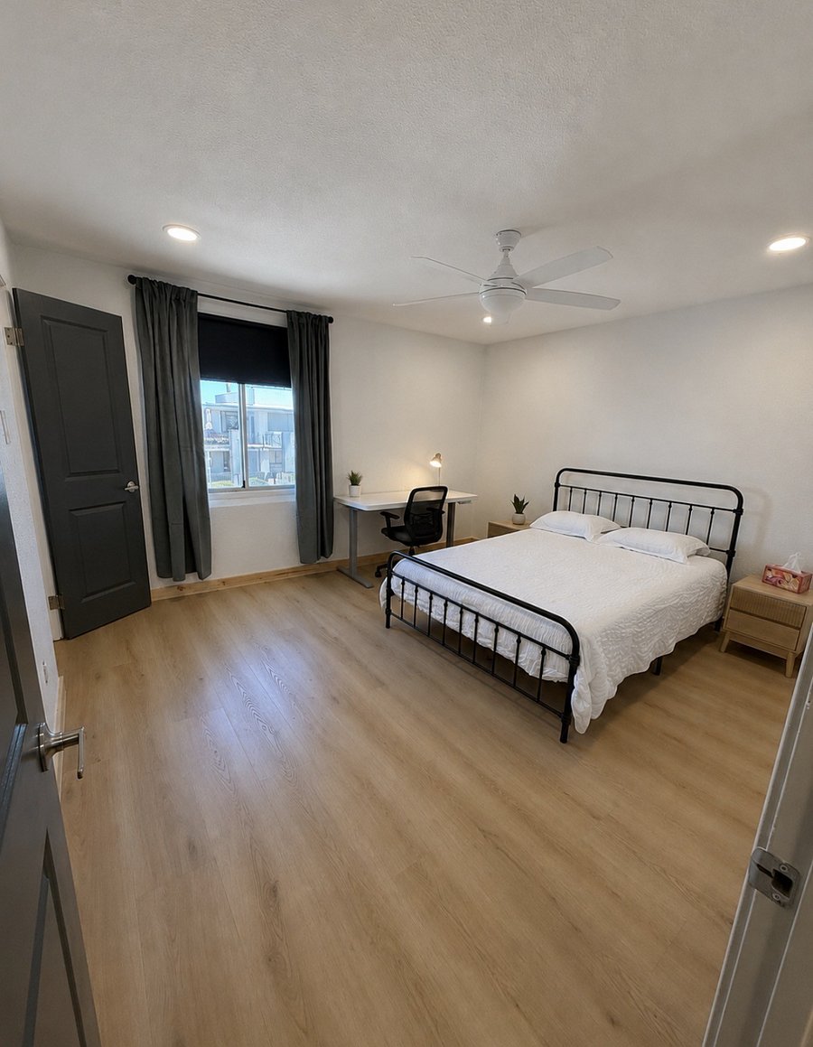 Functional room with walk-in closet and views of the pool. Height adjustable desk.