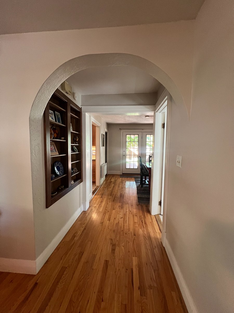 Hallway off living room that leads to dining and kitchen areas