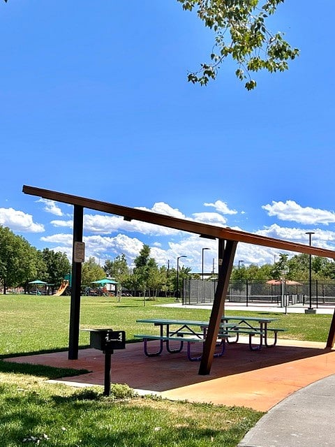 Shaded bench area + newly installed children's playground in background