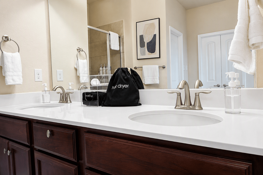 Spacious master en-suite with dual sinks, sleek fixtures, and ample counter space - perfect for couples or shared routines.