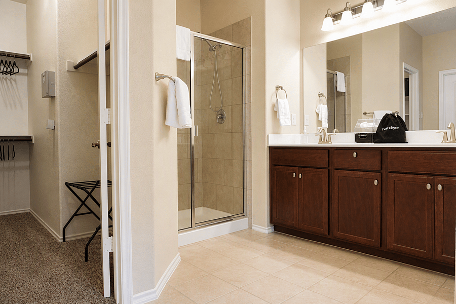 Spacious master suite with walk-in closet, convenient luggage rack, and elegant en-suite bath for effortless comfort.  