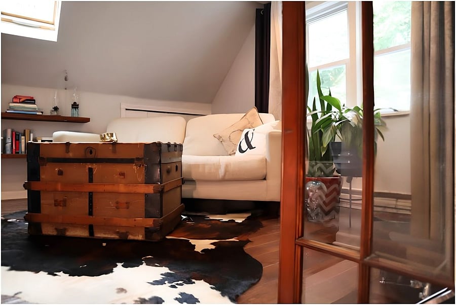 Upstairs is one large loft space with couch, desk & chair, coffee table and dresser.