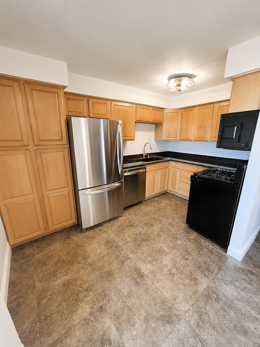 Fully renovated kitchen with granite counters and stainless appliance.