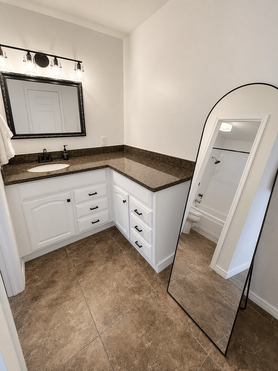 Primary bathroom with granite counters and toilet closet with bathtub-shower.