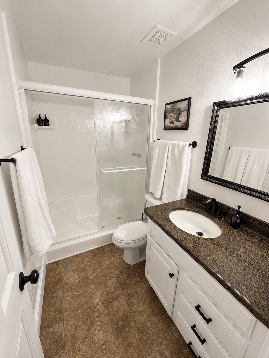 Main bathroom with granite counters and walk in shower.
