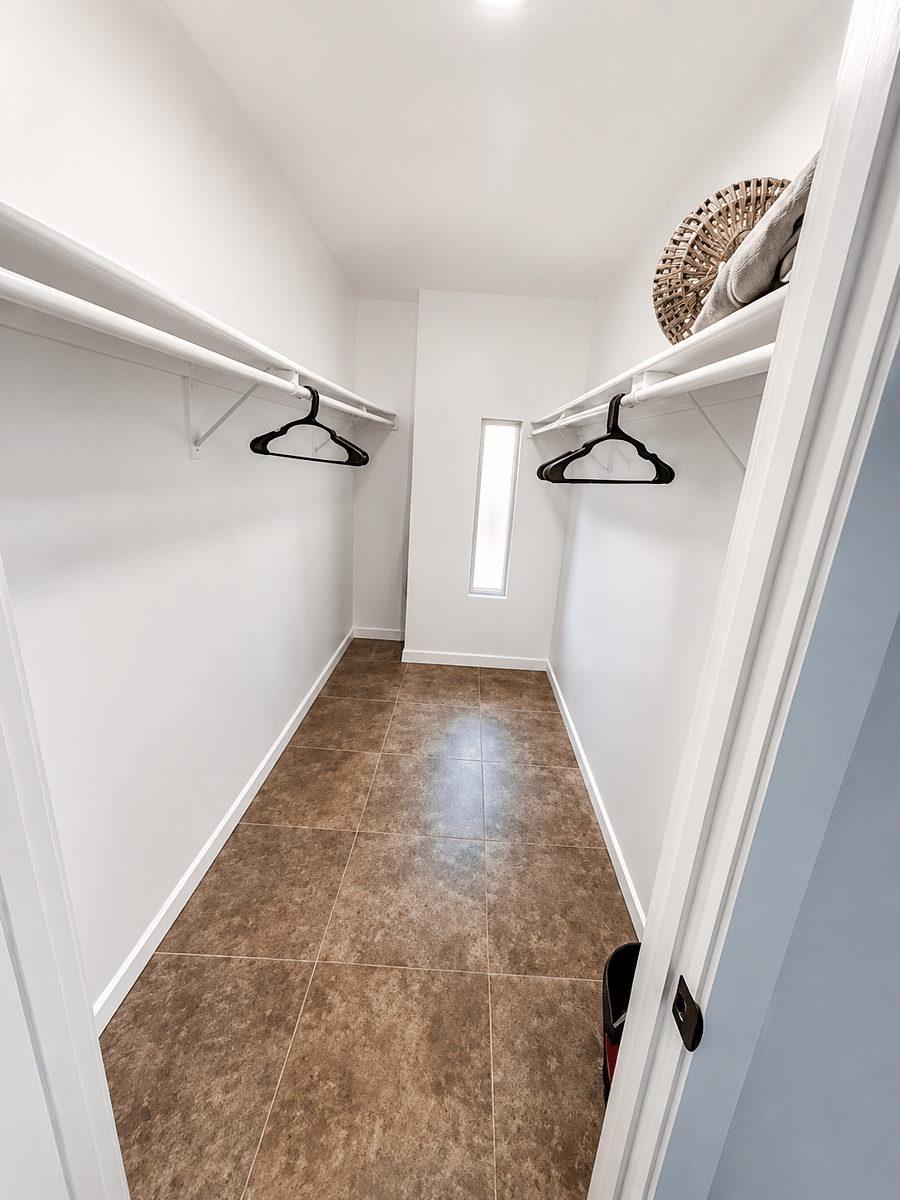 Spacious primary bedroom with walk in closet.