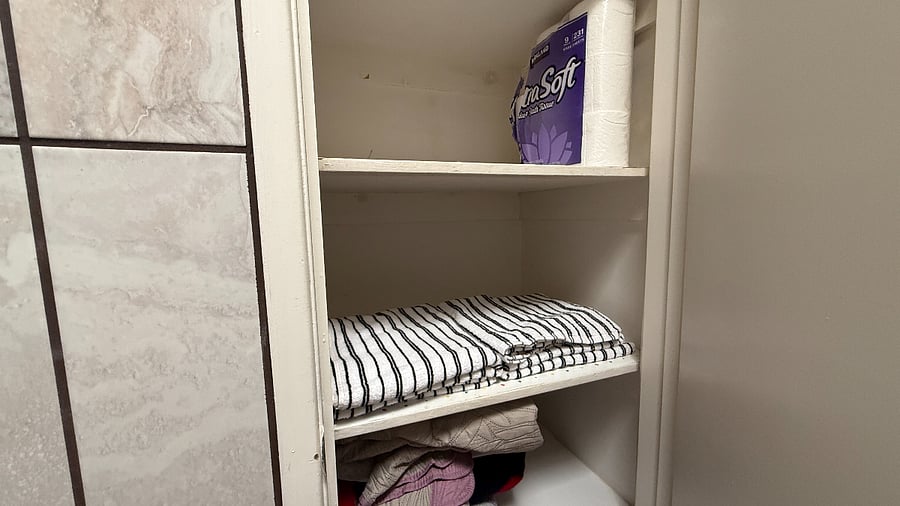 Extra Towels in the Bathroom closet along with a package of toilet Paper