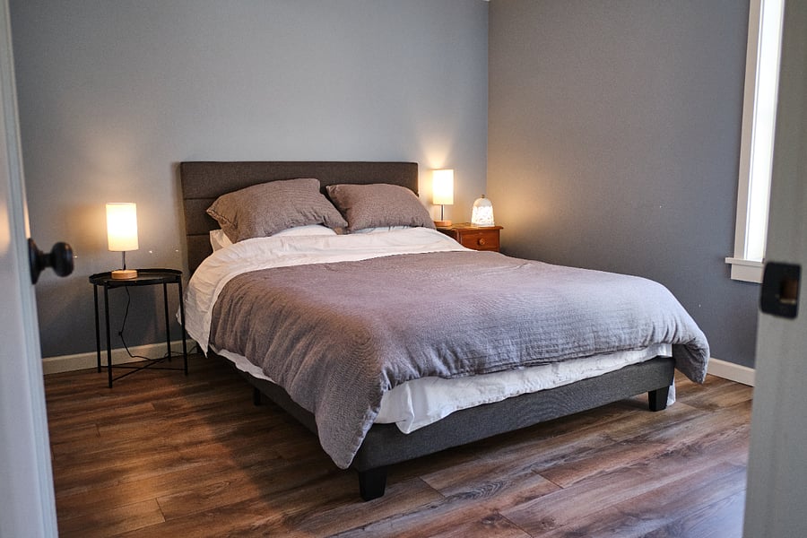 Bedroom with south-facing window, closet, and dresser.