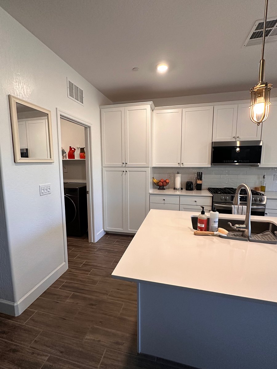 Laundry room off kitchen with electric washer/ dryer