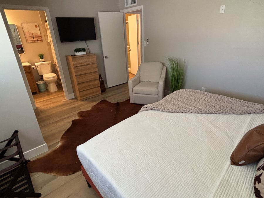 Primary bedroom with king bed, smart tv and plenty of closet/storage space