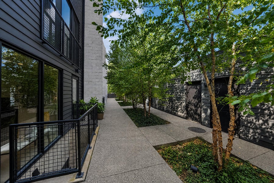 Courtyard view and entrance to unit and garage