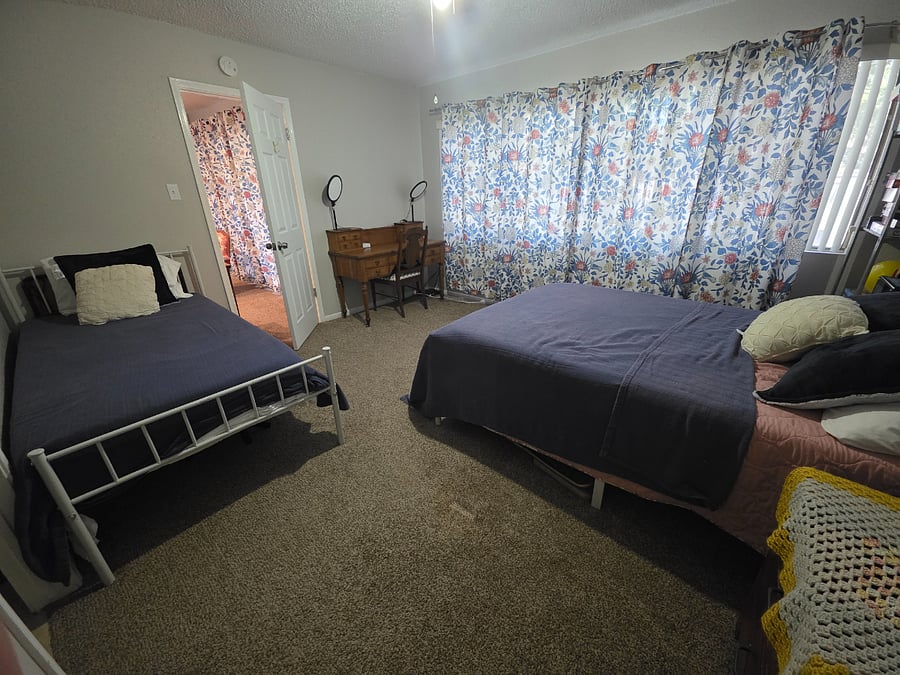 Guest bedroom with private bath and antique desk for working.