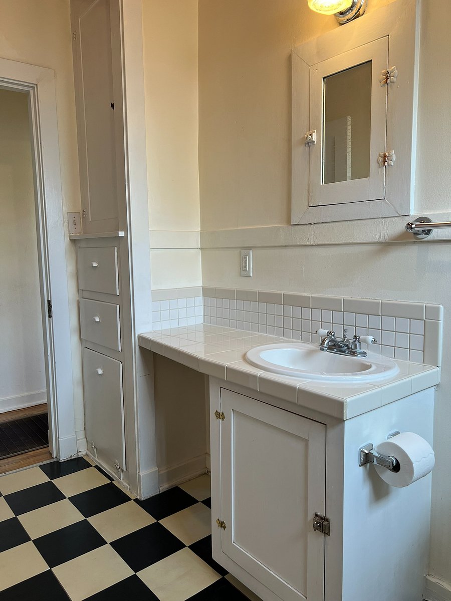 Built-in linen closet with hamper.