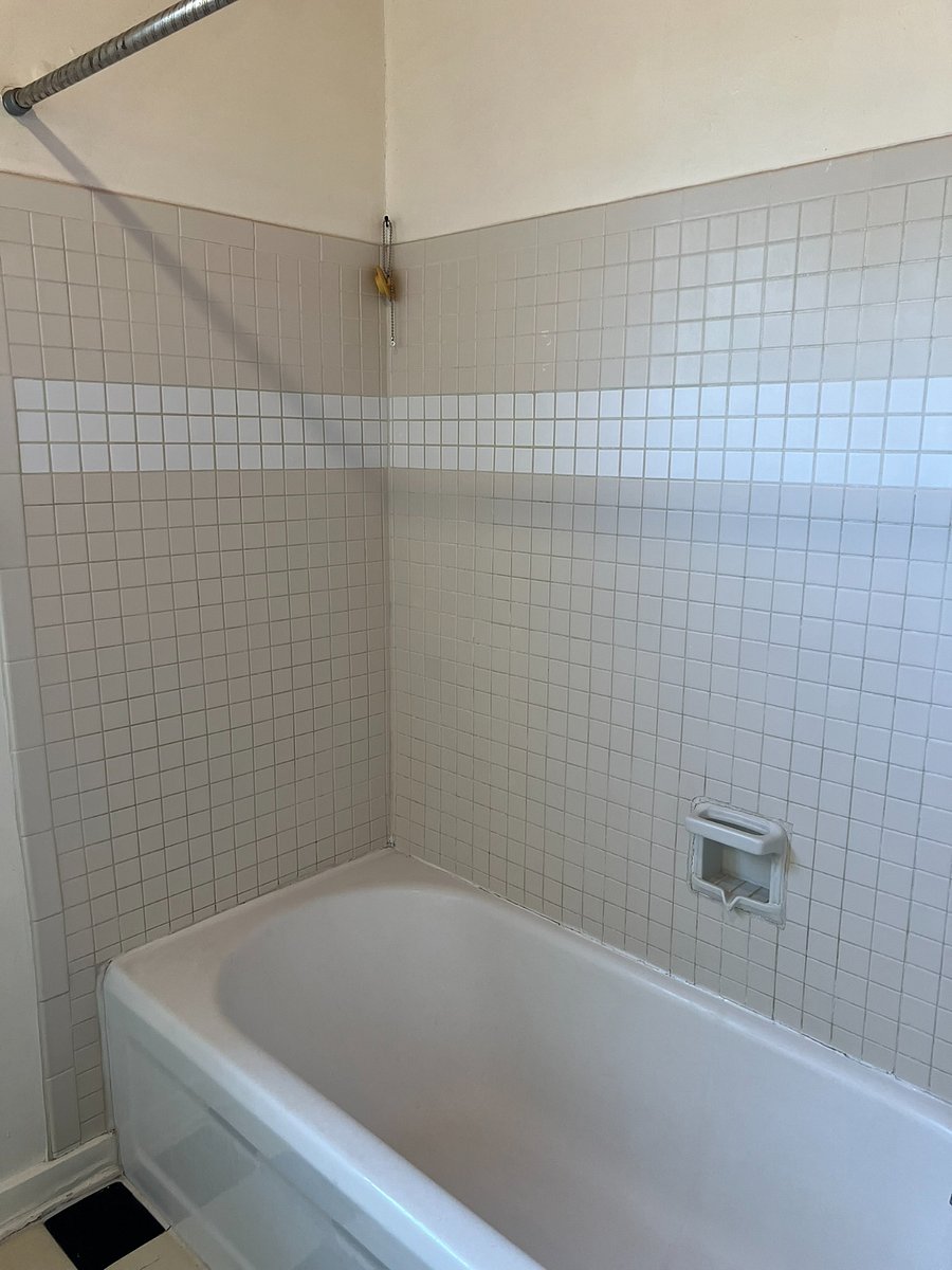 Full tub/shower with tile surround.