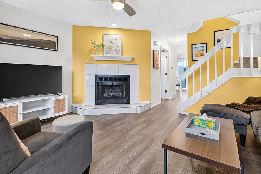 Living room off of front entrance featuring Smart TV, fireplace, Mountain views, books and puzzles for guest use