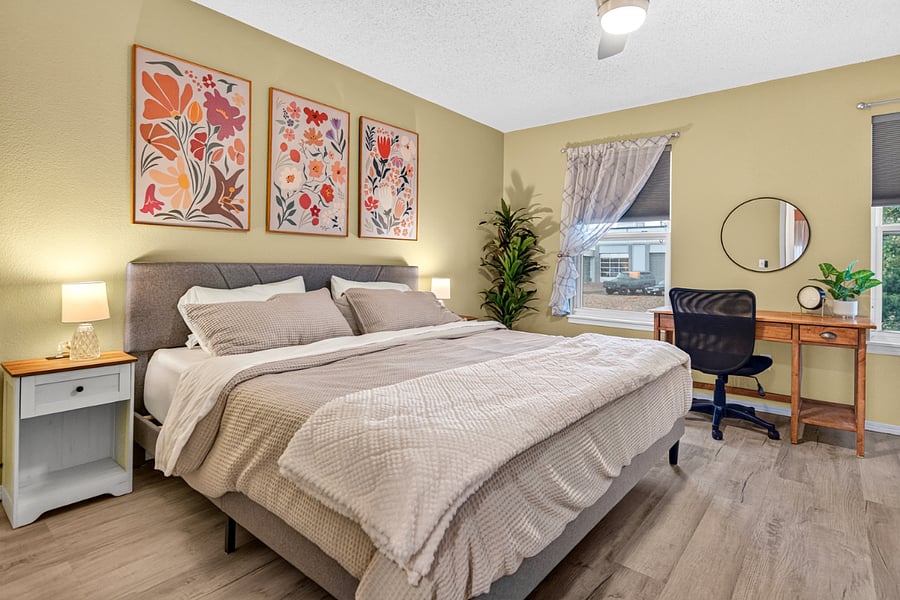 Primary bedroom featuring king bed, mountain views, dedicated workspace, room-darkening shades, plentiful closet space, and smart TV for guest use.