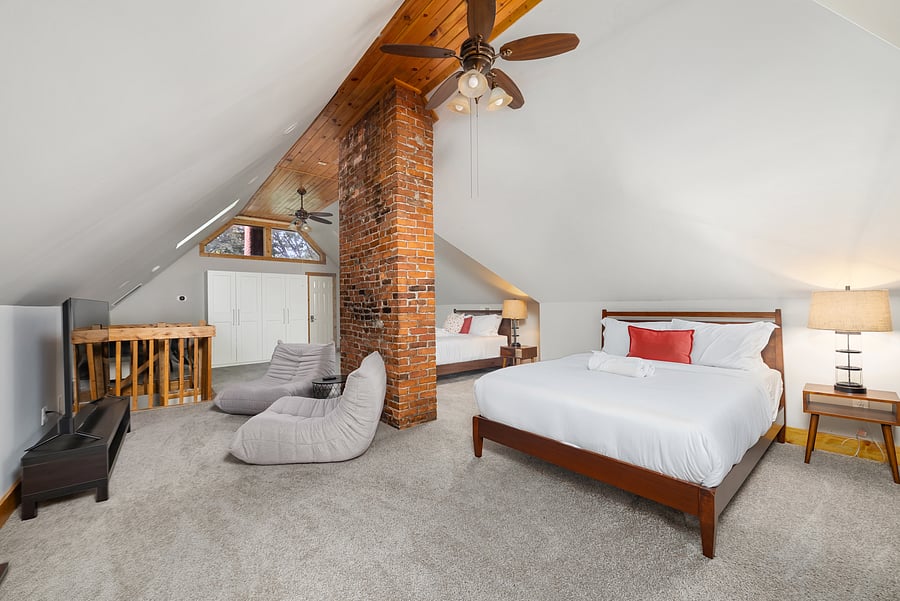 Expansive third-floor retreat with exposed brick and flexible sleeping space