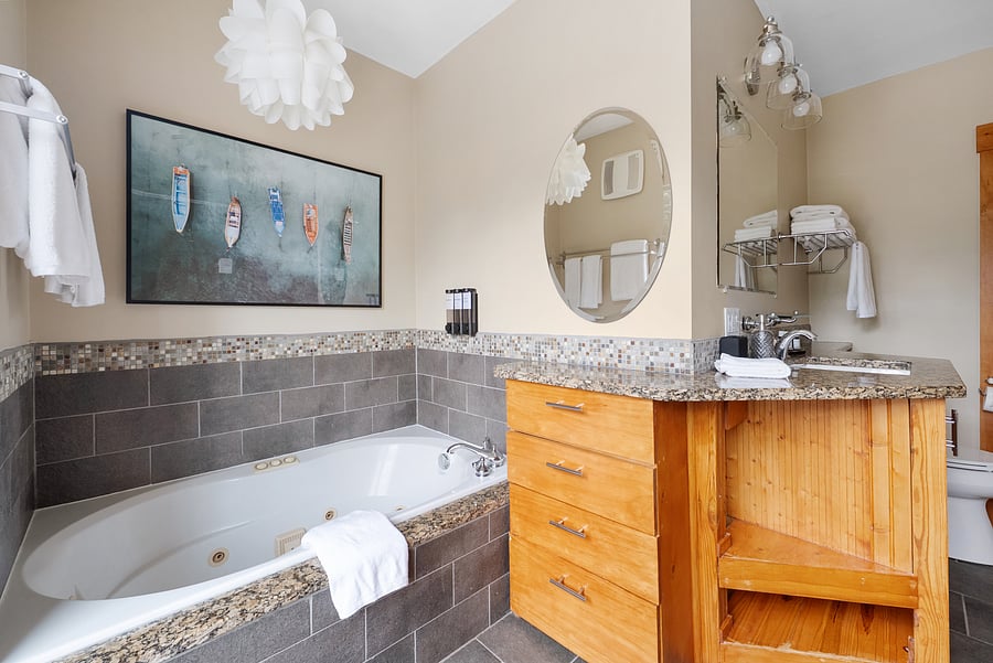 Unwind in the private ensuite bathroom with a relaxing soaking tub