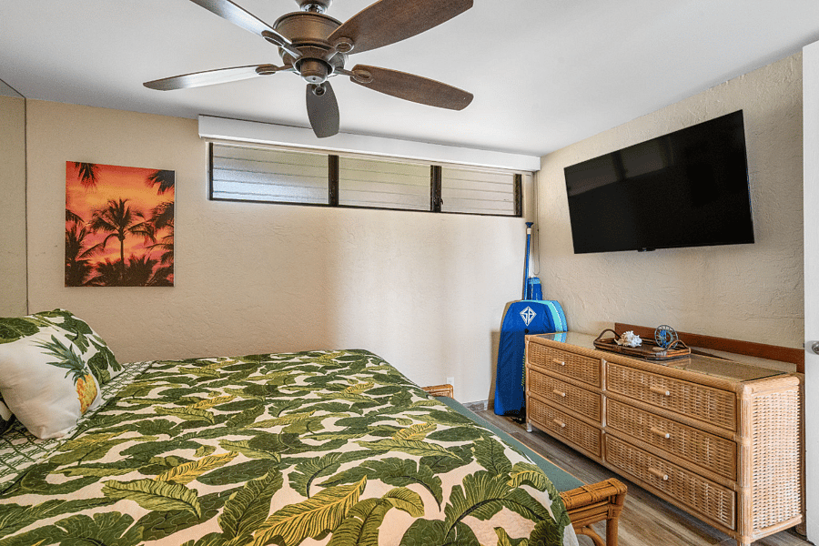 Comfortable cal king bedroom with ceiling fan, smart TV, and convenient access to the remodeled bathroom.