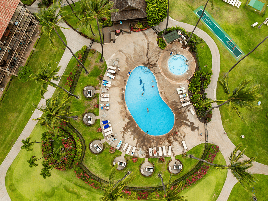 Aerial view of one of Papakeas two oceanfront pool areas, each featuring a swimming pool, hot tub, six BBQ grills, and a covered gazeboperfect for relaxing, swimming, or enjoying an outdoor meal.