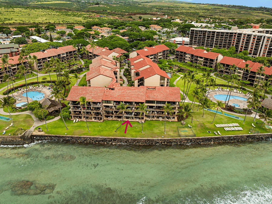 Aerial view from the oceanfront side of Papakea Resort. Our ground-floor condo is marked by the red arrow, with direct access to the oceanfront lawn and beautiful sunset views.