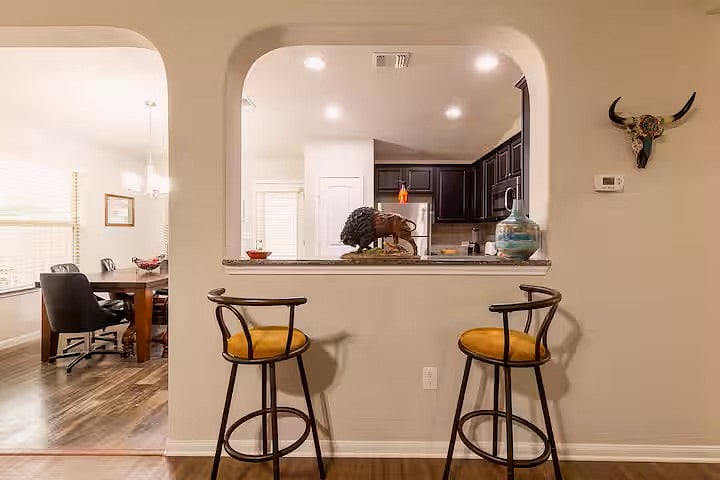 view of dining area, kitchen and counter with barstools