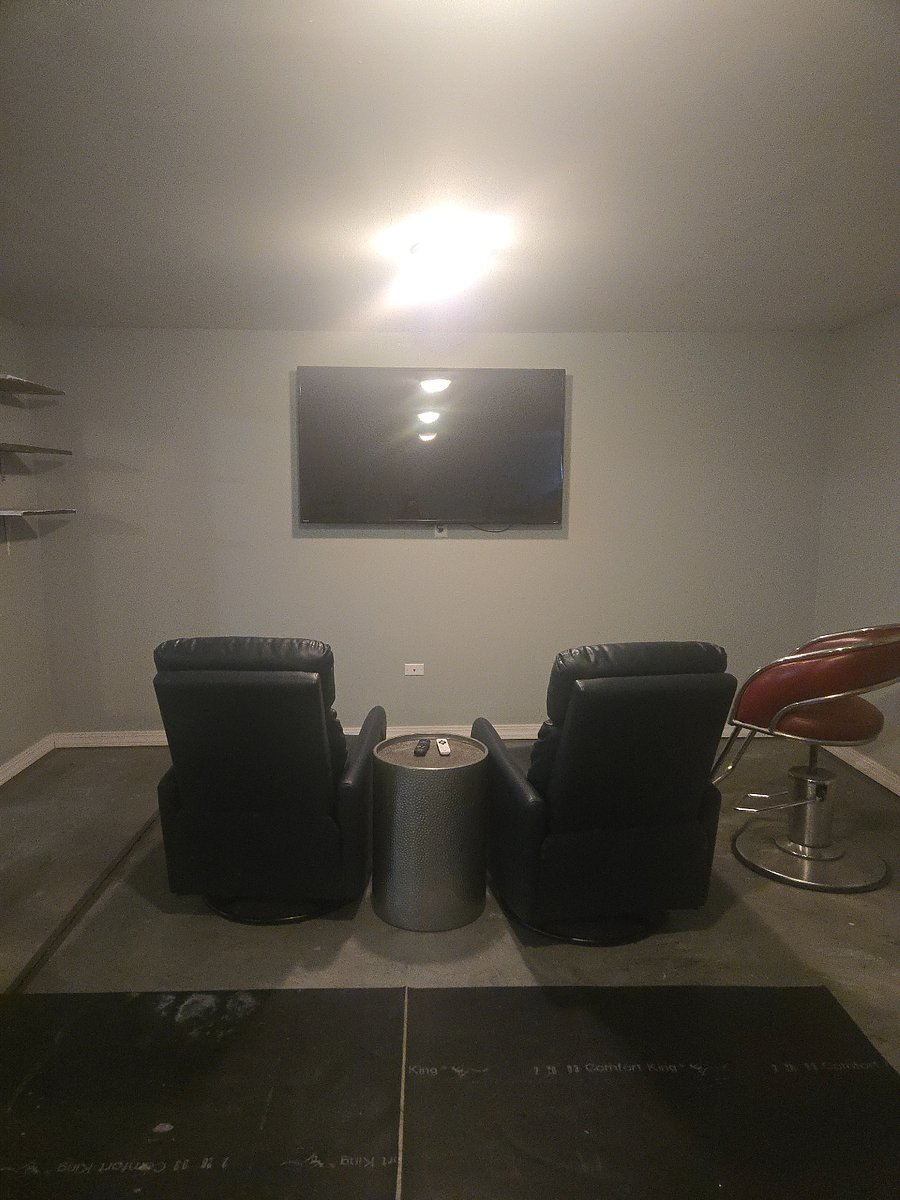 Basement: View of TV, reclining chairs, and barber chair