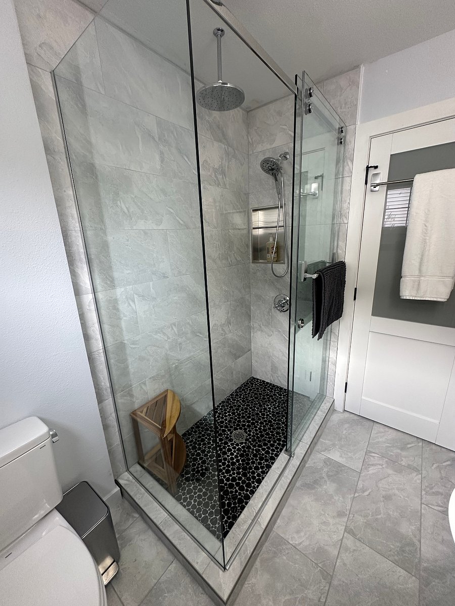 View of the rain shower and traditional showerhead with removable wand.View