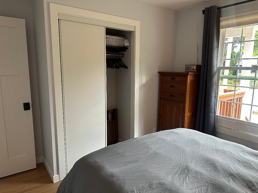 View of the front bedroom facing South with dresser and closet.