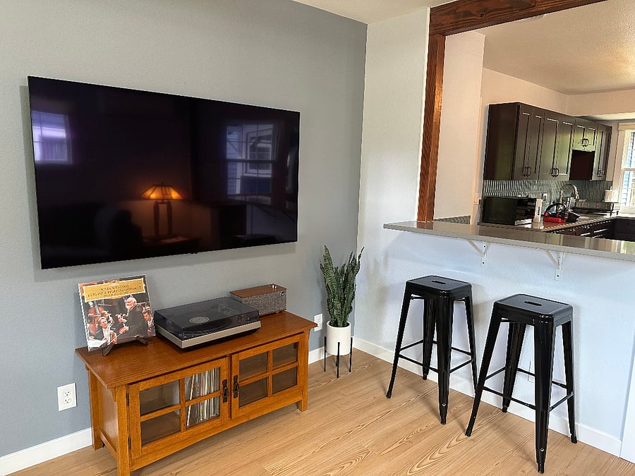 View of the 65" OLED TV, record player, and island.