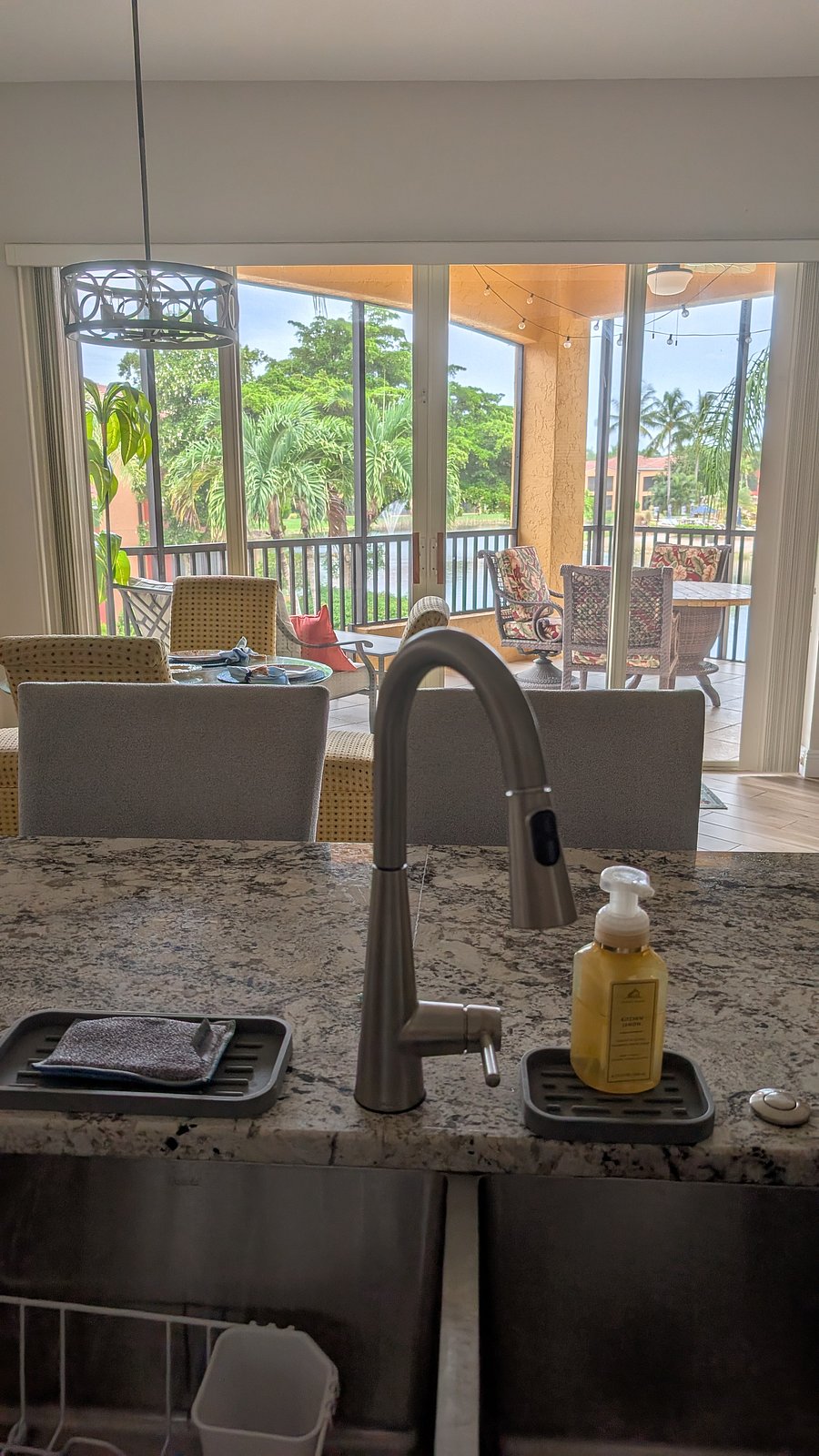 View from kitchen to lanai with outdoor dining set