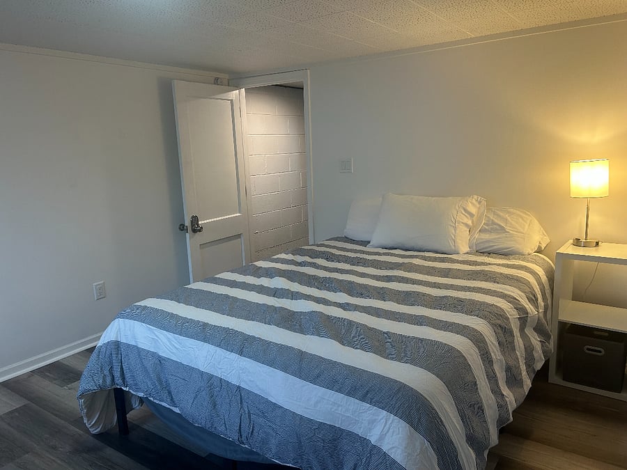 Queen bed in large basement bedroom; cool, quite room with blackout curtains