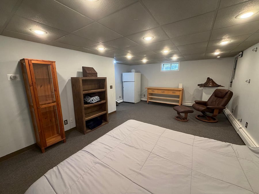 Furnished area of basement with queen bed