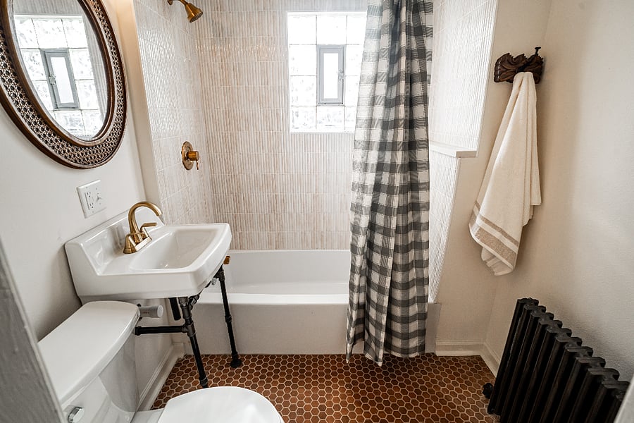 Updated bath with new tub, tile, fixtures and flooring