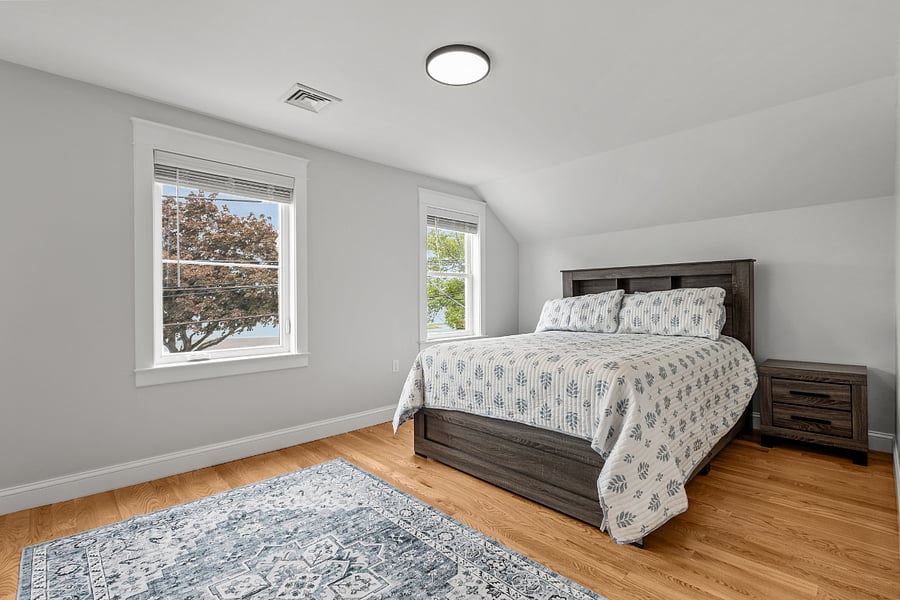 Primary bedroom featuring a queen bed overlooking Bristol Harbor 