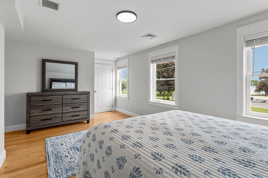 Primary bedroom featuring a queen bed overlooking Bristol Harbor 