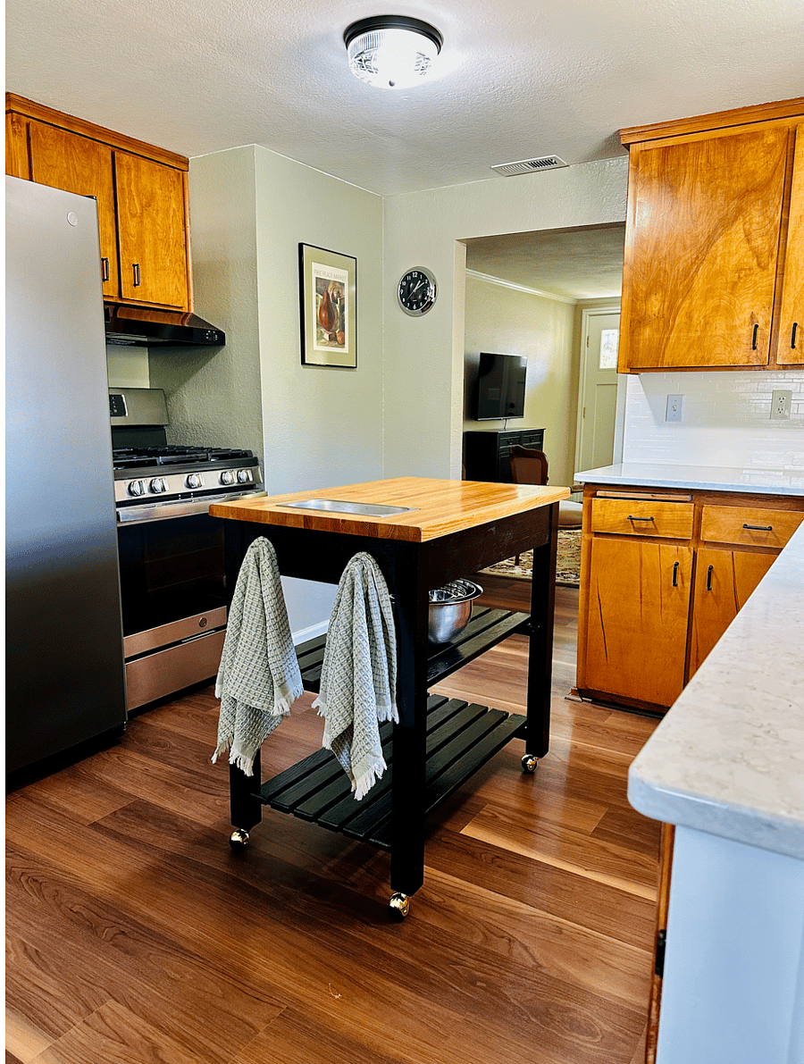 Kitchen with amenities, gas range, quartz countertops and a dishwasher
