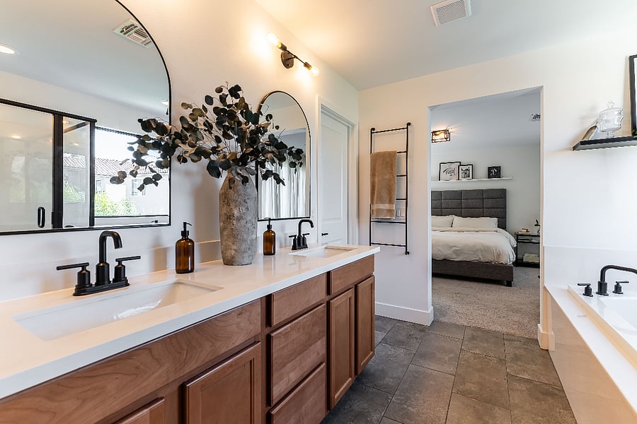 Private attached bathroom with a separate shower, soaking bathtub and double vanity.