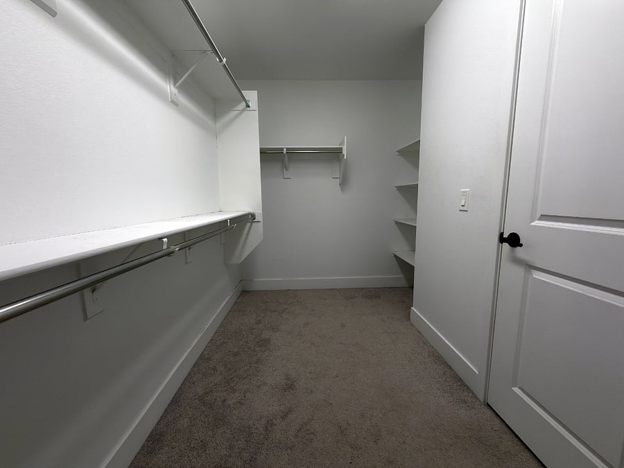 Private oversized walk-in closet attached to bathroom.