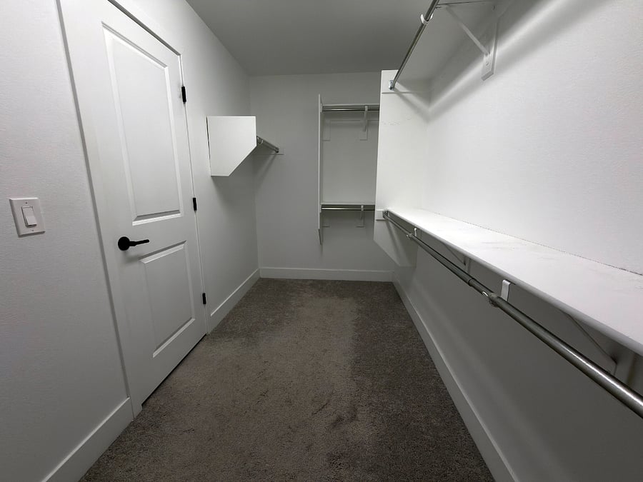 Private oversized walk-in closet attached to bathroom.