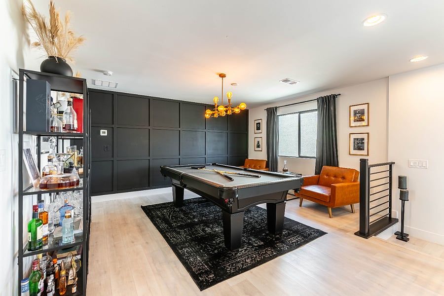 Unique lounge space for unwinding. Pool table has been removed, but bar setup and lounge chairs remain.