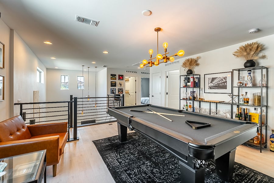 Unique lounge space for unwinding. Pool table has been removed, but bar setup and lounge chairs remain.