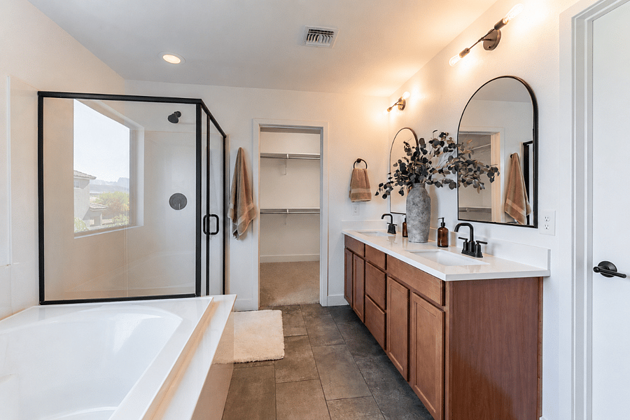 Private attached bathroom with a separate shower, soaking bathtub and double vanity.
