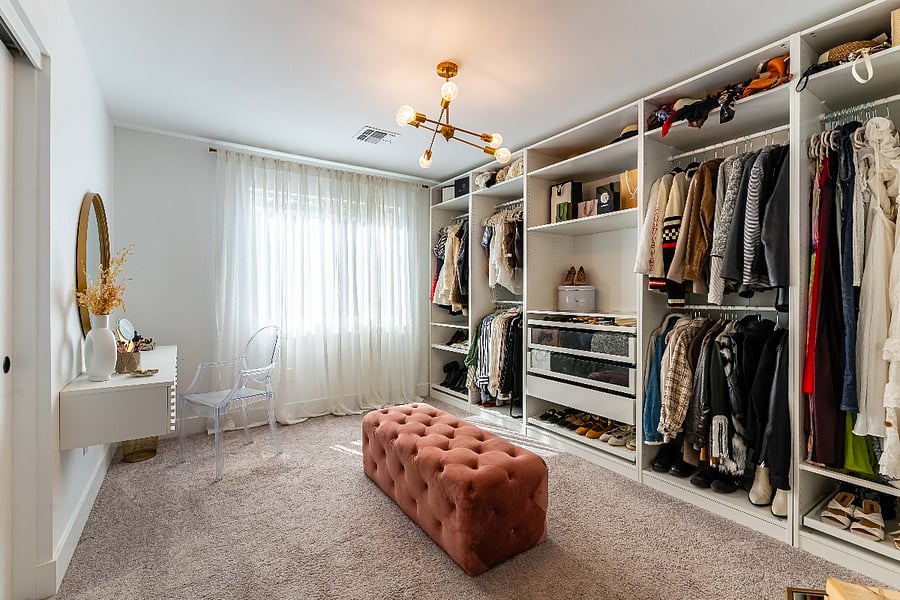 This closet organizer has been removed and added a queen bed. The vanity and mirror are still in the room.
